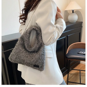 Chic grey faux shearling shoulder bag with metallic chain strap shown in a modern interior