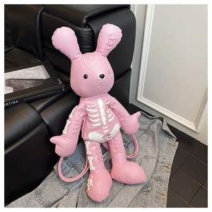 Close-up of pink rabbit backpack with white skeleton print and stitched leather detail