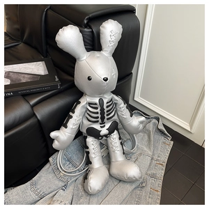 Detail showing metallic silver rabbit backpack with skull print and cross stitching