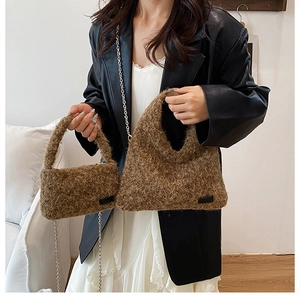 Detail view of brown plush handbags in large and small sizes with golden chain strap