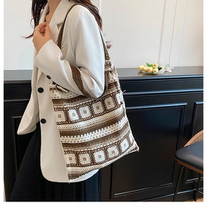 Detail of hand-knit geometric pattern tote bag in coffee brown and cream white finish
