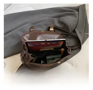 Detailed interior of a brown vintage PU leather backpack with spacious compartments