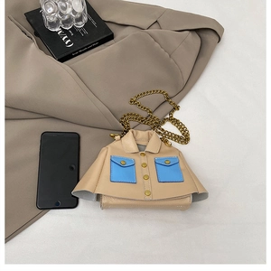 Detailed view of mini jacket-shaped crossbody bag with gold chain and blue pockets