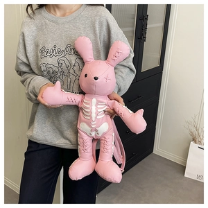 Detailed view of pink rabbit-shaped backpack featuring gothic skeletal design and PU leather