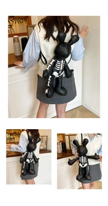 Close-up of black rabbit-shaped PU leather backpack with skeleton print in a cafe