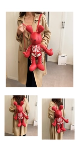 Three-way view of red rabbit gothic backpack with white skeleton print and straps