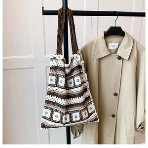Detail of vintage crochet shoulder bag with checkerboard pattern and floral accents