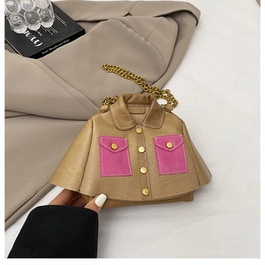 Close-up of a khaki jacket-shaped mini crossbody bag with pink pockets and gold chain strap