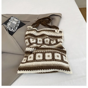 Close-up of vintage crochet knit shoulder bag with brown and beige granny square patterns