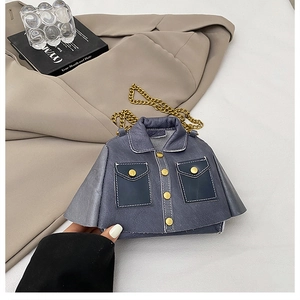 Detailed view of mini jacket-shaped crossbody bag with gold chain and denim fabric