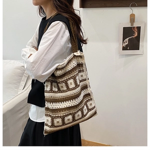 Detail of crochet knit tote bag with brown and beige geometric pattern and wide strap