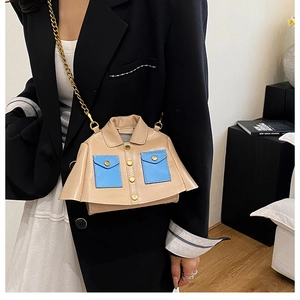 Detailed shot of creative jacket-shaped crossbody bag with nude leather and blue pocket accents