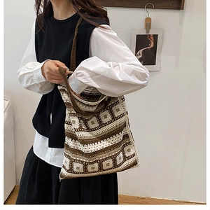 Detailed knit shoulder bag showing brown and cream geometric crochet patterns