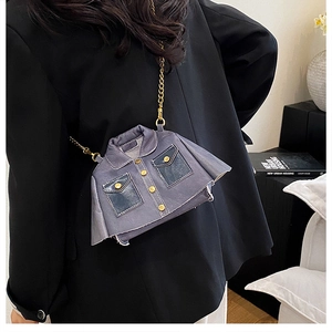 Detail of jacket-shaped crossbody bag in grey-blue leather with gold chain and buttons