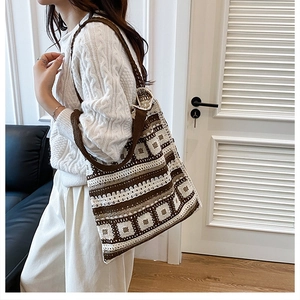 Detail of bohemian hand-knitted tote bag featuring vintage geometric crochet textures