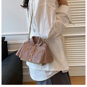 Detailed view of the pink jacket-shaped crossbody bag with gold chain and buttons
