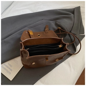 Detail view of the brown PU leather backpack interior with organized compartments