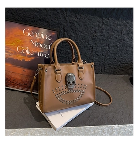 Détail du sac cabas marron avec crâne métallique et rivets sur fond de style rétro