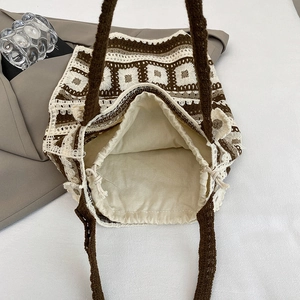 Ethnic knit shoulder bag in brown checkered pattern with drawstring lining on white background