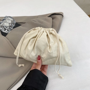 Ethnic style beige drawstring knit shoulder bag with natural woven fabric texture
