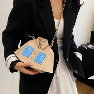 Unique jacket-shaped crossbody bag in beige leather with blue pockets and gold chain strap