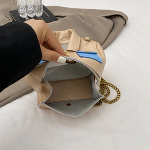 Beige jacket-style crossbody bag with chain strap and stylish button details
