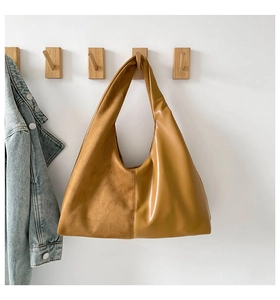 Detail of hobo bag featuring ginger suede and matte leather contrast stitching