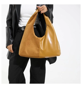 Hobo bag detail showing mustard yellow oil wax leather and suede stitching contrast