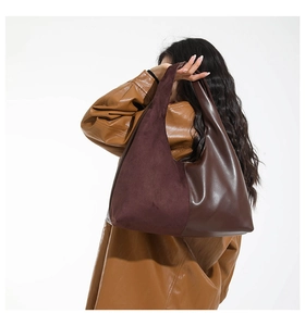Detail showing vintage burgundy suede and dark brown leather stitching on hobo bag