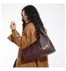 Close-up of contrast tote bag showing brown leather and coffee suede material textures