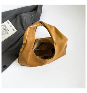 Detail view of caramel faux leather tote bag with patchwork texture and inner pocket