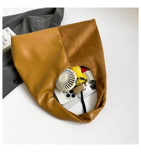 Top view of large tan tote bag showing spacious interior with commuter essentials