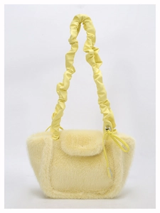 Detailed view of cream plush handbag featuring soft long faux fur and ruched shoulder strap