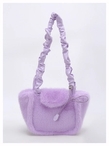 Detail of lavender plush faux fur handbag with a scrunchie leather handle and bow