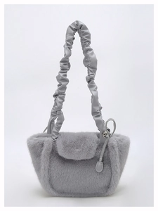Detail of the gray faux fur handbag featuring a stylish pleated scrunchie leather strap