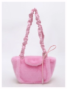 Detail of pink faux fur shoulder bag with ruched PU handle and soft plush texture