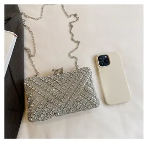 Detail of silver rhinestone evening clutch with chain showing size capacity for phone