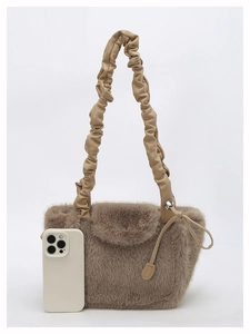 Detailed view of plush coffee-colored tote bag with pleated faux leather handle and phone size reference