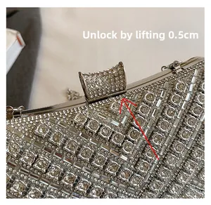 Detail of opening method for silver rhinestone evening clutch with lift-up metal clasp