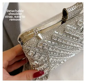 Detail view of silver clutch bag with rhinestones and detachable metal chain strap