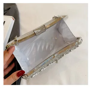 Detail of the silver rhinestone clutch bag showing white satin lining and spacious interior