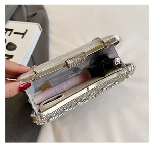 Detail view showing interior capacity of a silver rhinestone evening clutch bag with chain