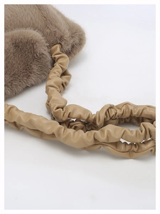 Detailed close-up of khaki faux fur texture and elegant ruched leather shoulder strap