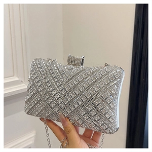 Macro shot of silver evening clutch bag featuring diagonal rhinestone mesh and metal chain
