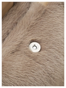 Macro detail of silver magnetic clasp on premium khaki faux fur shoulder bag