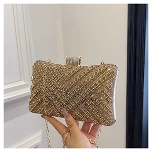 Detailed close-up of gold rhinestone clutch bag with luxury V-shaped geometric texture