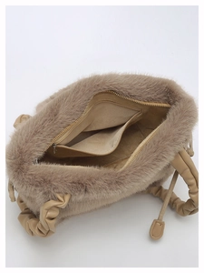 Detail view of khaki plush handbag interior with zip pocket and ruched leather handle