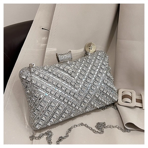 Close-up of luxury evening clutch bag featuring shimmering rhinestones and silver chain strap