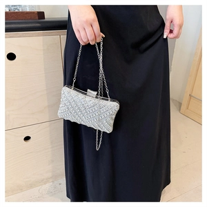 Detailed macro view of the silver rhinestone evening clutch bag with metal chain strap
