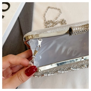 Detail of silver rhinestone clutch bag with inner satin lining and detachable chain strap